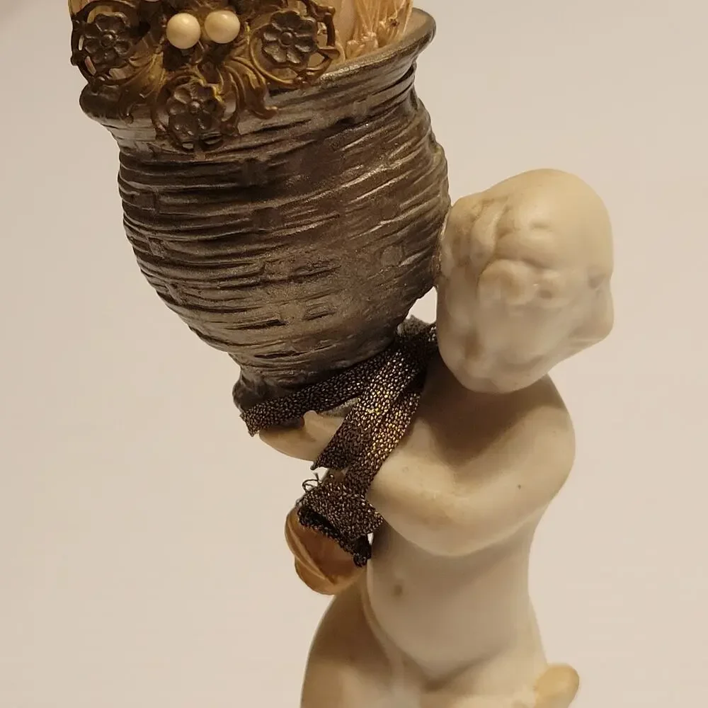 Vintage child cherub figurine with vase
